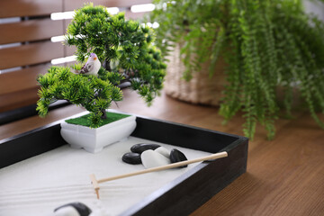 Beautiful miniature zen garden on wooden table, closeup