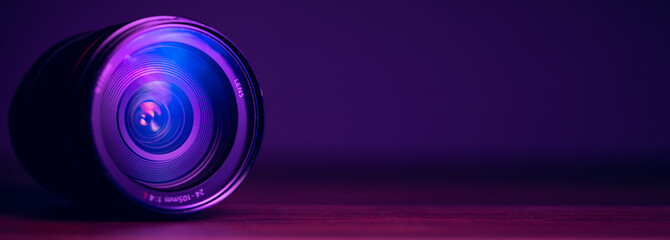 camera lens with lens reflections on purple background