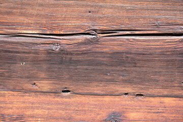 Naklejka premium Old and weathered dark brown cracked wood beam surface with nice rough grain texture.