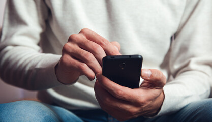 male hands using smart phone