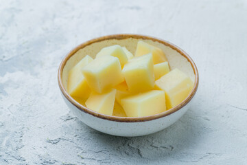 sheep's cheese on plate on white concrete table