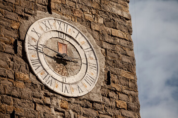 Selective blur on the vintage stone ancient clock of the clocktower of the parish church of saint george, or zupnjiska cerkev svetog jurija, a major landmark of the slovenian istria, in Piran