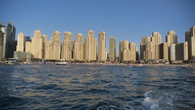 Dubai Marina Beach UAE, Beachfront Apartment Towers and Buildings, Off Coast View From Moving Boat, Slow Motion