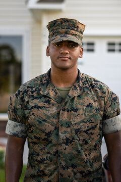 Marine service member arrives home in his car and walks into his house.