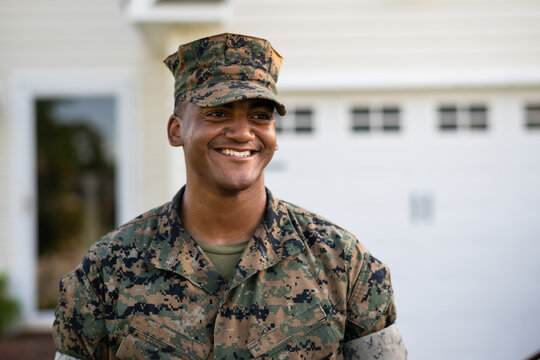 Marine service member arrives home in his car and walks into his house.