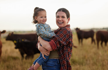 Family, mother and baby on a farm with cows in the background eating grass, sustainability and...