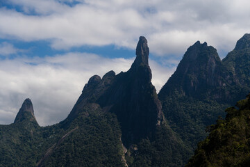 Fototapeta na wymiar Famous mountain surrounded by hills located in the Teresópolis mountain range, in Rio de Janeiro, Brazil known as God's finger 