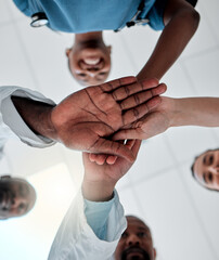 Goal of a group of doctors with their hands together in support, unity and trust together ready for...