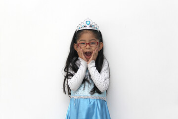 Poor 4-year-old Latin brunette girl is dressed as a happy princess with her costume to go to a...