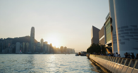 People walk at the water promenade in the evening