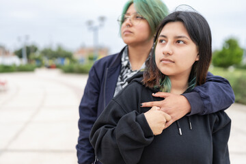 Lesbian couple embraced in the street