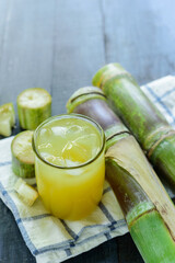 Fresh squeezed sugar cane juice, Sugar cane juice, Sugar cane drink with ice, on wood background