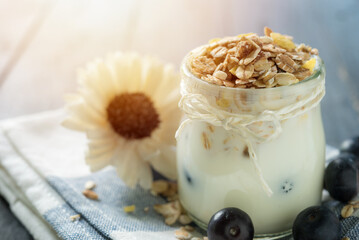 yogurt with oat , fresh blueberry on a wooden background. healthy cereal morning breakfast.
