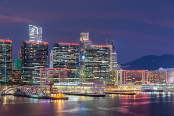 Fototapeta na wymiar High rise office building and pier in Hong Kong city at dusk