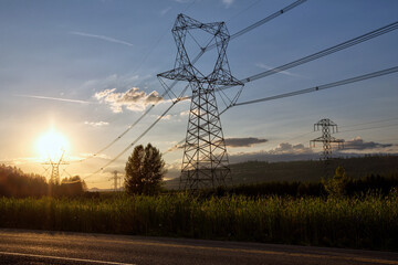 High Voltage Power Transmission Lines on Towers During Golden Sunset in Rural Oregon Over Fields Near Road © Kirk