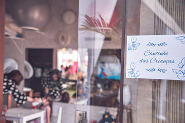 a glass door of a toy library with a sign that says: 