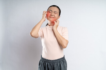 Asian woman was sick with irritate itching her skin with red spot standing isolated on white...