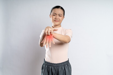 Asian woman was sick with irritate itching her skin with red spot standing isolated on white...