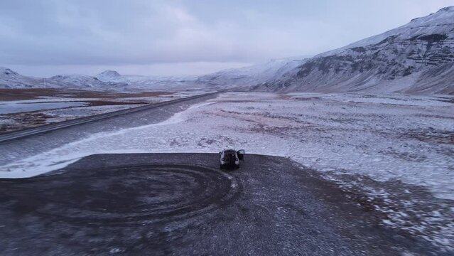 Couple Alone In The Middle Of Nowhere On A Car Park, Iceland. Winter TIme