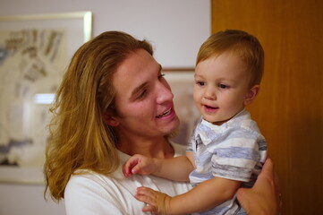 Obraz na płótnie Canvas Handsome young man holding his little nephew