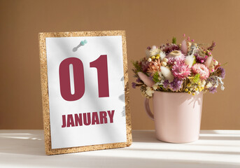 january 1. 1th day of month, calendar date.Bouquet of dead wood in pink mug on desktop.Cork board with calendar sheet on white-beige background. Concept of day of year, time planner, winter month