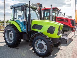 Modern wheeled tractors in the parking lot