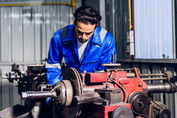 Professional labor machanic engineer technician worker industrial man wearing blue safety uniform working control with heavy machine in manufacturing  factory production line.business industry