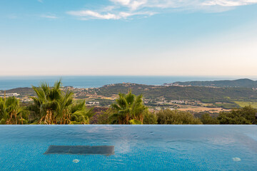 Holiday Lifestyle Swimming Space. Outdoor luxurious pool on the open air with a beautiful view of sea on Costa Brava, Spain.