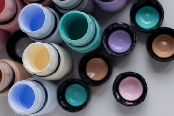 Many bottles of colorful paints staying open