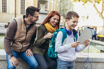 Young parents taking their little child to school