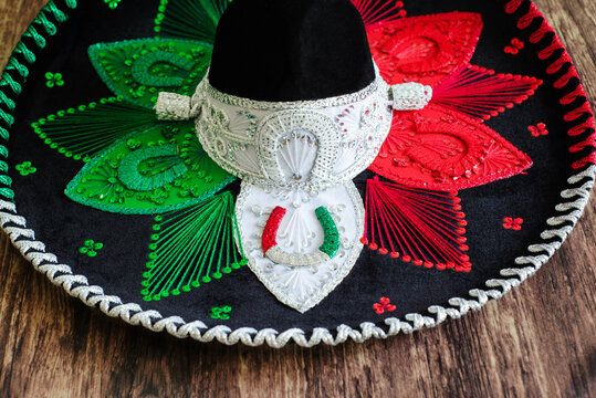 Mexican charro hat on wooden table. Typical mexican hat with the colors of the mexican flag.