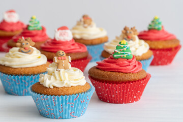 Close-Up of Assortment of Christmas Cupcakes on Table, Selective Focus with White Background
