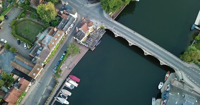 Impressive sunrise drone shot of Henley-on-Thames bridge and town centre.