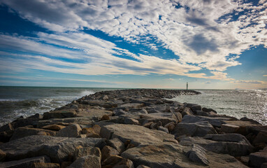 breakwaters and cloudy sky on barelona beach
