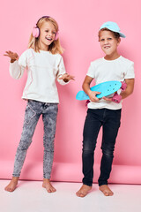 Fototapeta premium Stylish little boy and cute girl happy faces blue pink color background