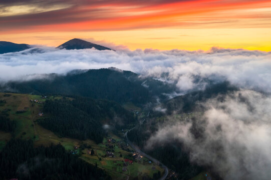 Aerial view of foggy sunrise in the mountains. Summer mountains.