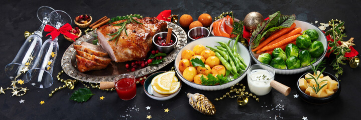 Traditional Christmas dinner on dark background.