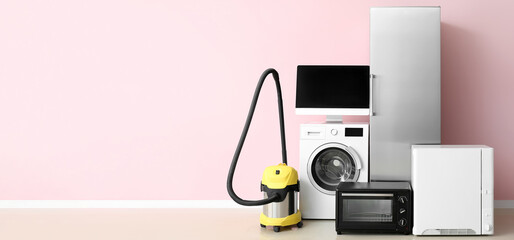 Different household appliances on light background with space for text