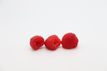 group of raspberries on white background