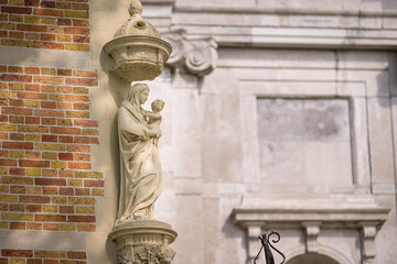 Statue of Holy Mary with child on a house in Bruges
