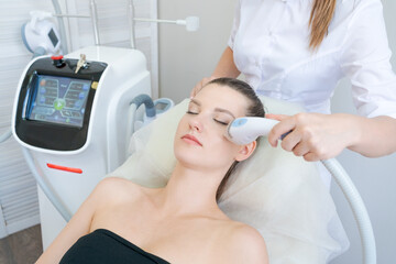 Gorgeous woman in beauty clinic receives non-surgical face lift. SMAS ultrasonic uplift. Facelift....