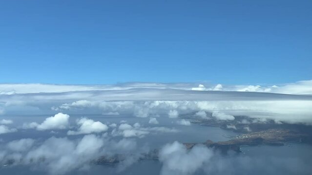 Aerial view from a jet cockpit of Madeira Island during the approach at 1000m high to Funchal airport in cloudy summer day. 4K 60FPS.