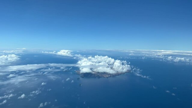 Aerial view of Porto Santo, next to Madeira. Portugal, covered with some clouds in a splendid summer day. Pilot POV. 4k 60 fps.
