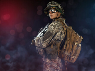 Woman army soldier in combat uniforms with assault rifle, plate carrier, goggles and backpack....