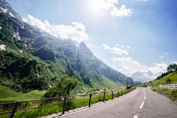 Asphalt road in Alp mountains. Road trip concept. Beautiful landscape.