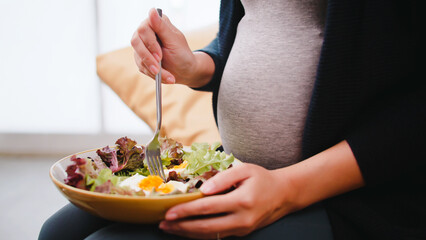 pregnant woman eats healthy food for her unborn baby.