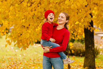 Happy family and autumn fun in the yellow park