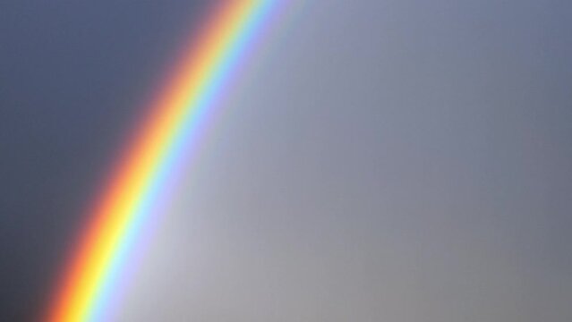 Rainbow over Sky and City and Mountain in Lugano, Ticino in Switzerland.