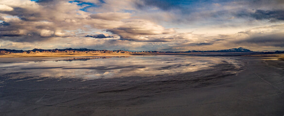 Fototapeta na wymiar sunset in the mountains with salt lake in desert reflecting sky