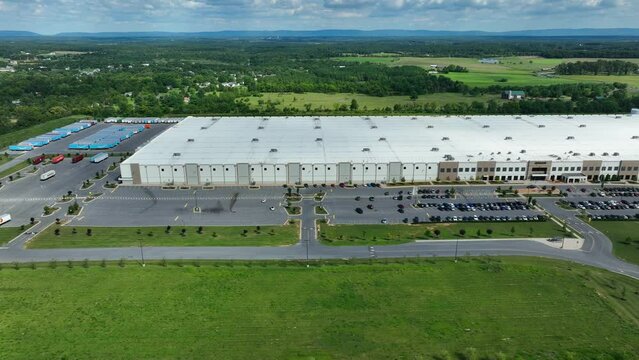 Huge Amazon distribution center warehouse. Aerial truck shot. Distribution and logistics theme.
